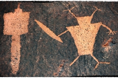 "Buff Alien StormTrooper with Light Sabre Assaults Hapless Droid""Buff alien StormTrooper with Light Sabre assaulting helpless droid"    Like I said, it is probably pointless trying to understand the original meaning of rock art.  Just let your imagination run loose and have fun with it.