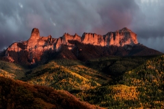 Chimney Rock in the Owl Pass area of Colorado's San Juan Mountains is a big grey block of granite...except for a few minutes when it gets direct light at sunset.  I had stood in a sleeting rain for nearly a hour, trying to stay dry and keep the mud out of my boots when the sun slipped under the overcast cloud cover just before it dipped under the horizon.  The way the mountain and autumn aspens exploded in color was worth every last, miserable, wet minute